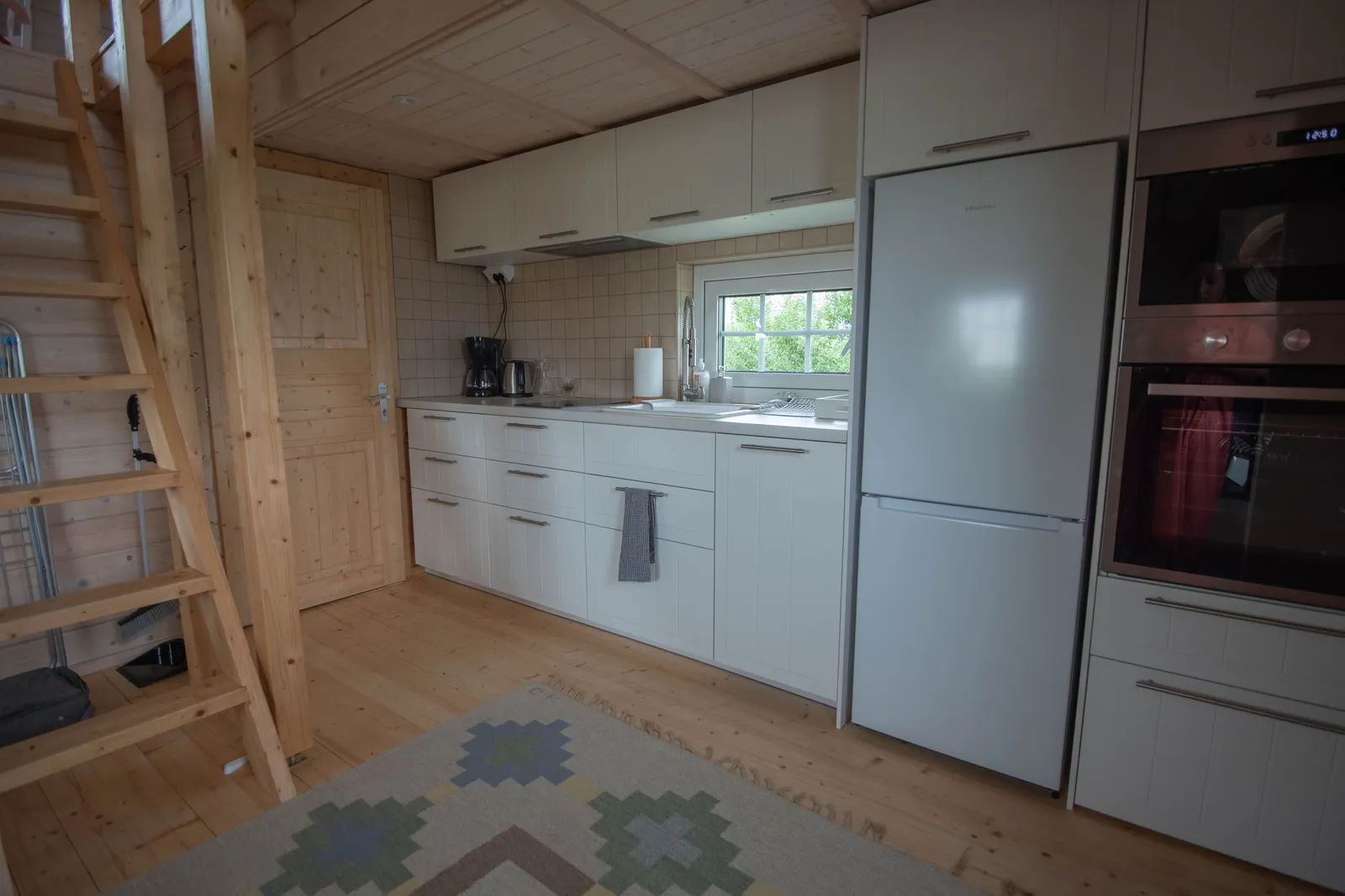 The kitchen with an oven and fridge